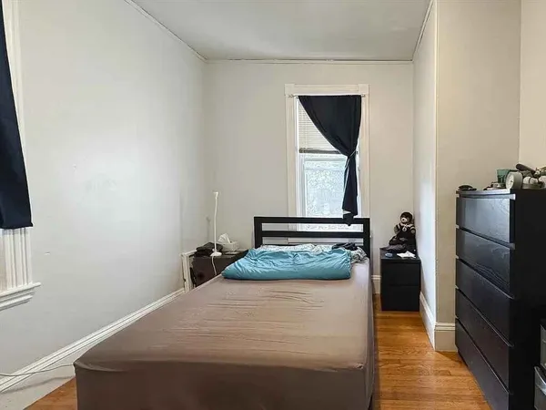 a bedroom with a bed and a large mirror