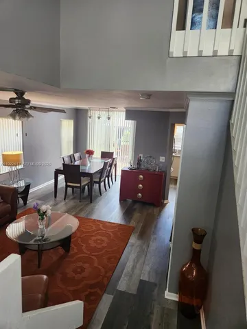 a living room with lots of furniture and a dining table