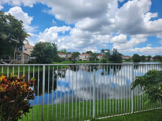 a large bed sitting in a bedroom next to a window