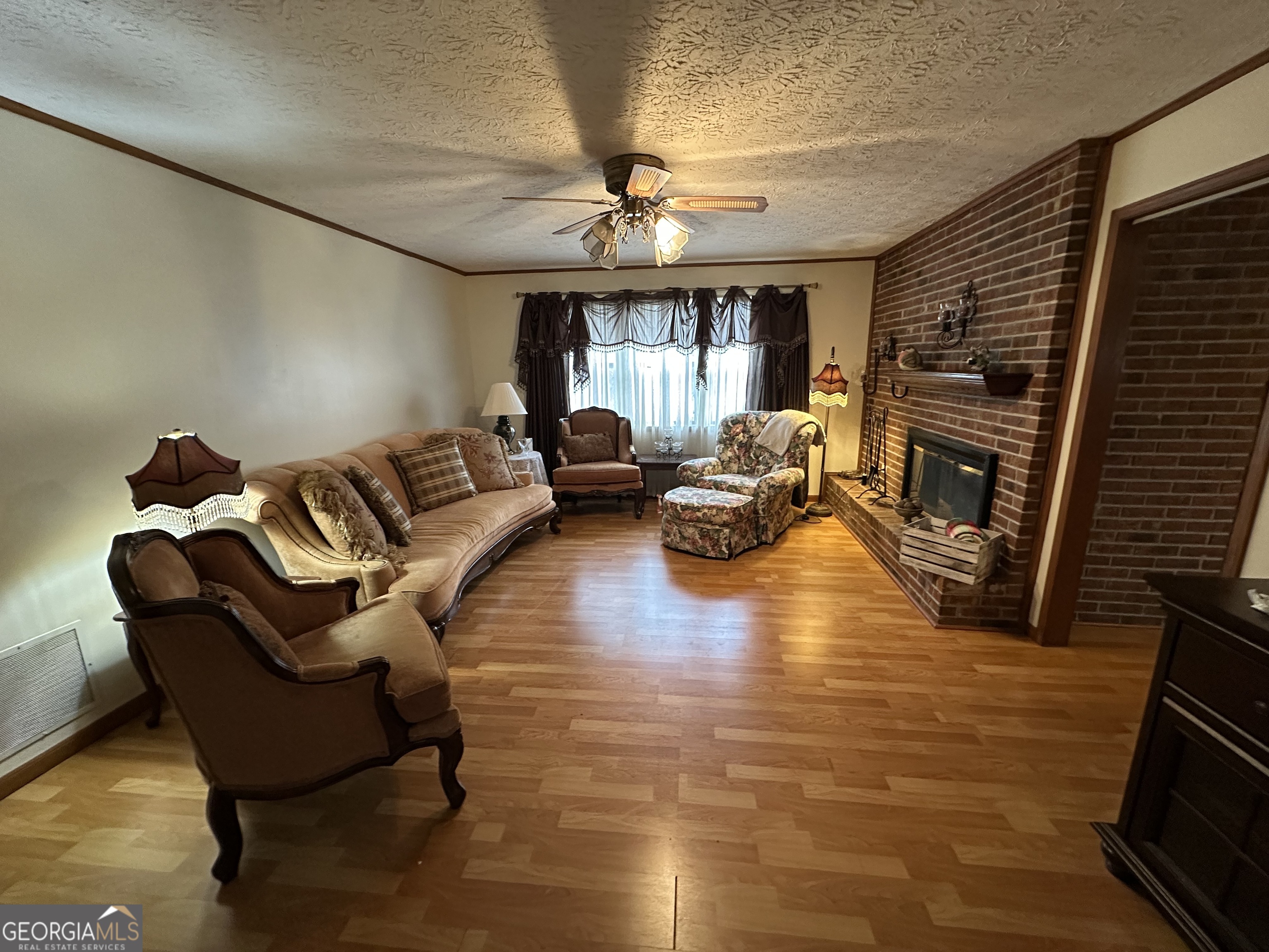 11306 Panhandle Road Hampton, GA 30228 - Photo 12 of 20 a living room with furniture and a fireplace