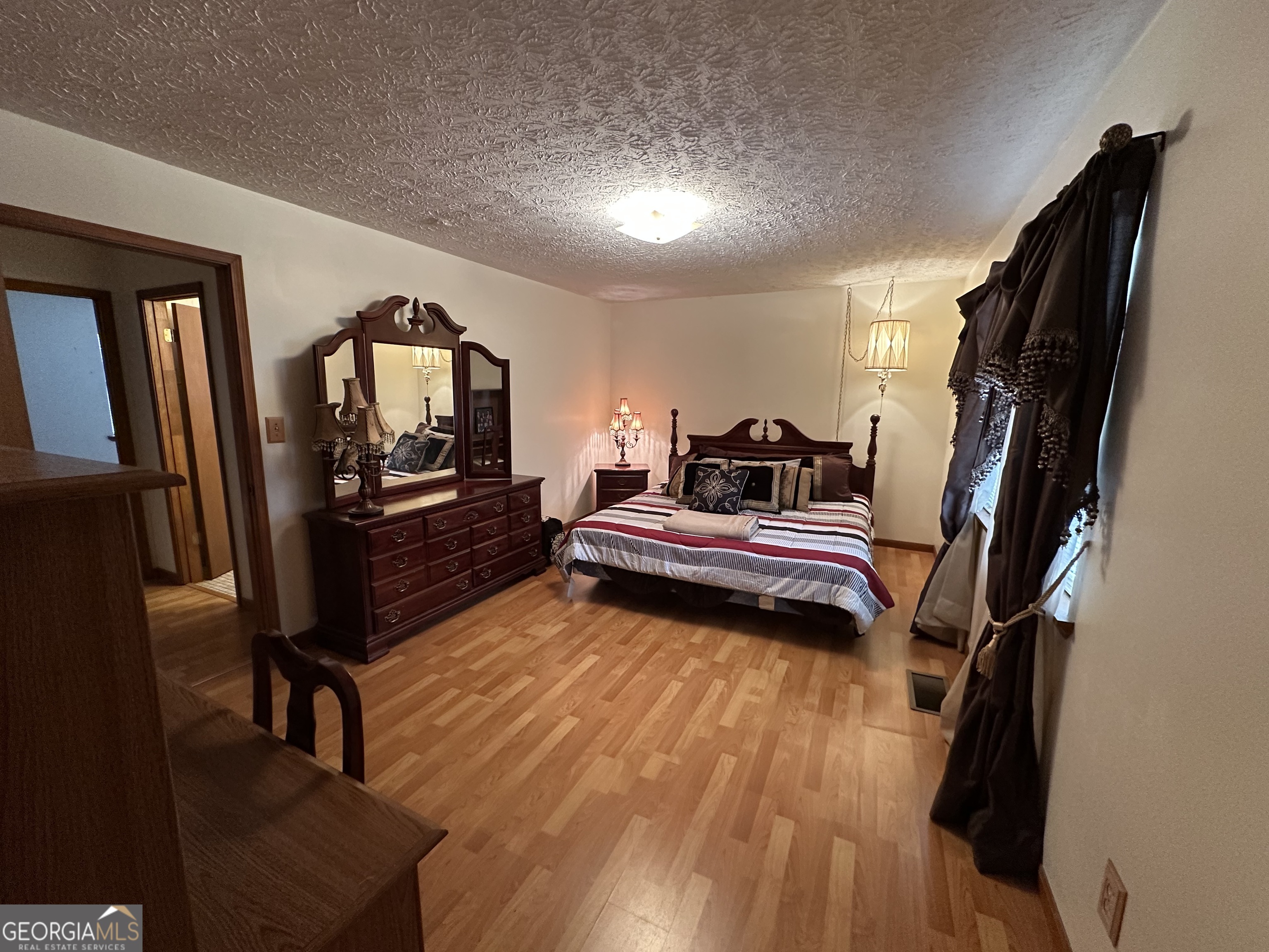 11306 Panhandle Road Hampton, GA 30228 - Photo 14 of 20 a living room with furniture and a wooden floor