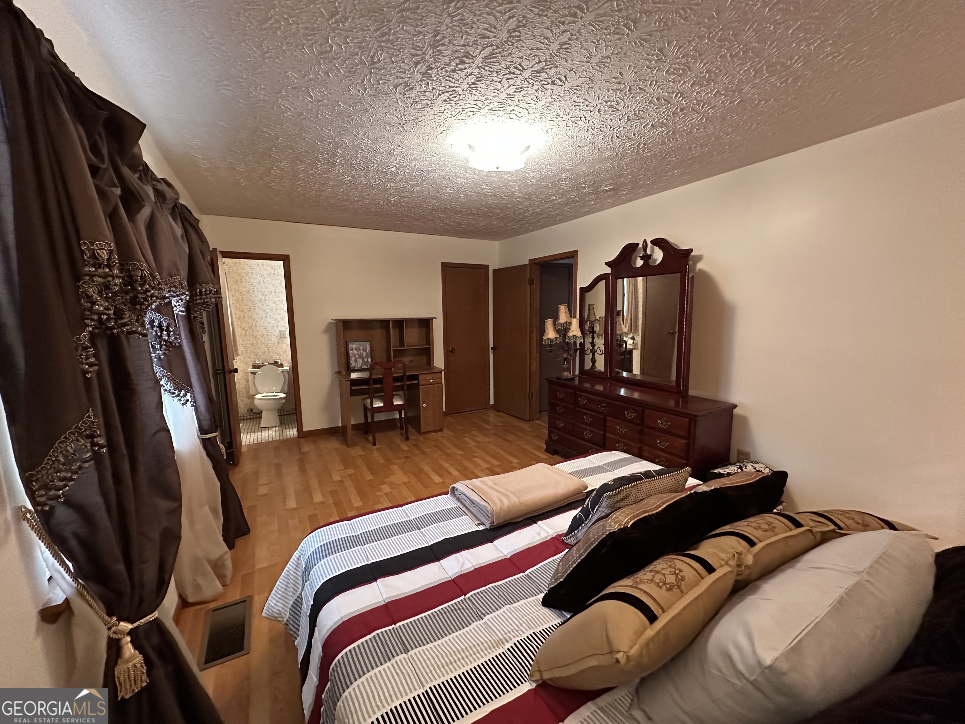 11306 Panhandle Road Hampton, GA 30228 - Photo 16 of 20 a bedroom with a bed and dresser
