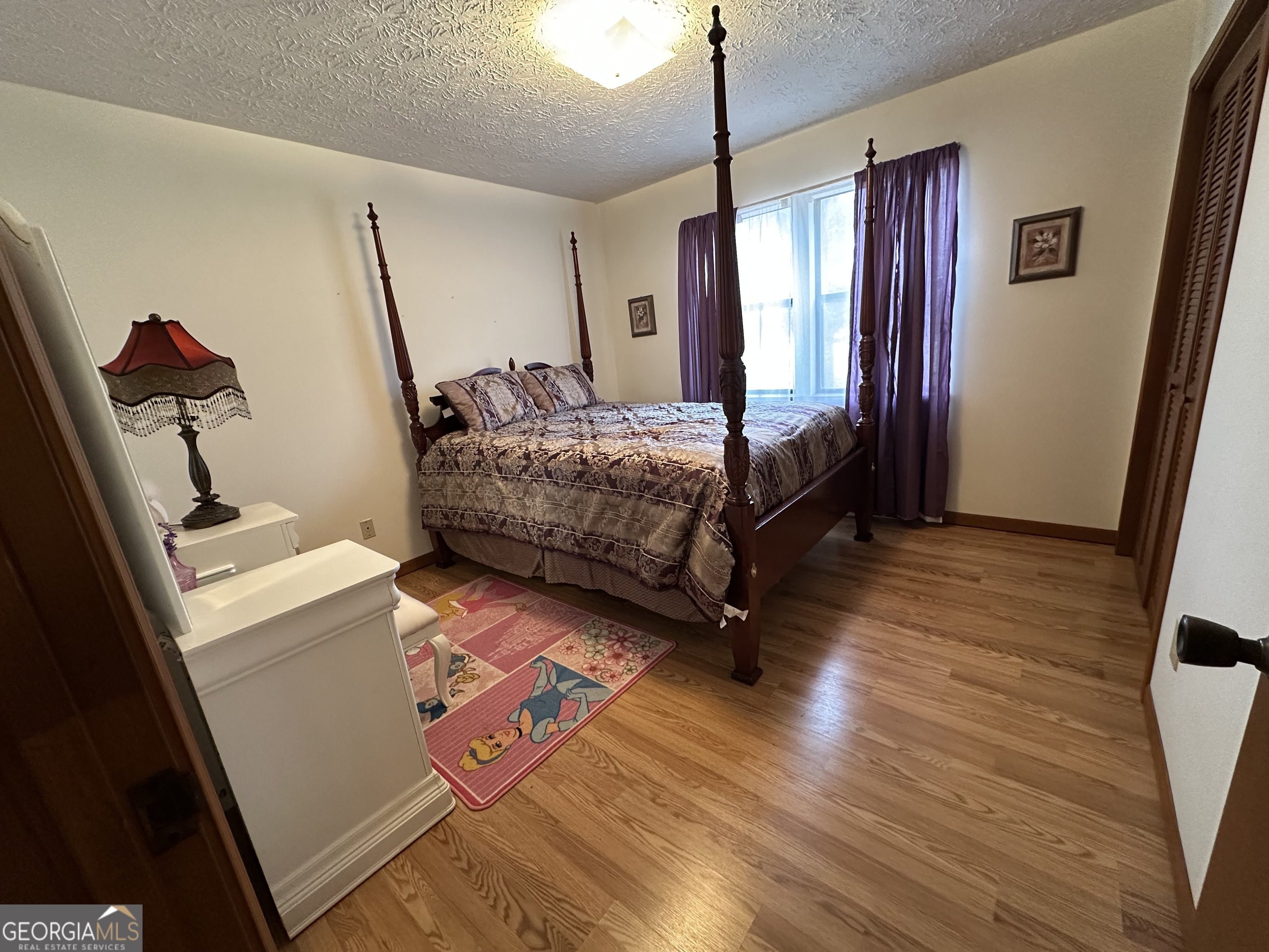 11306 Panhandle Road Hampton, GA 30228 - Photo 18 of 20 a bedroom with a bed next to a window
