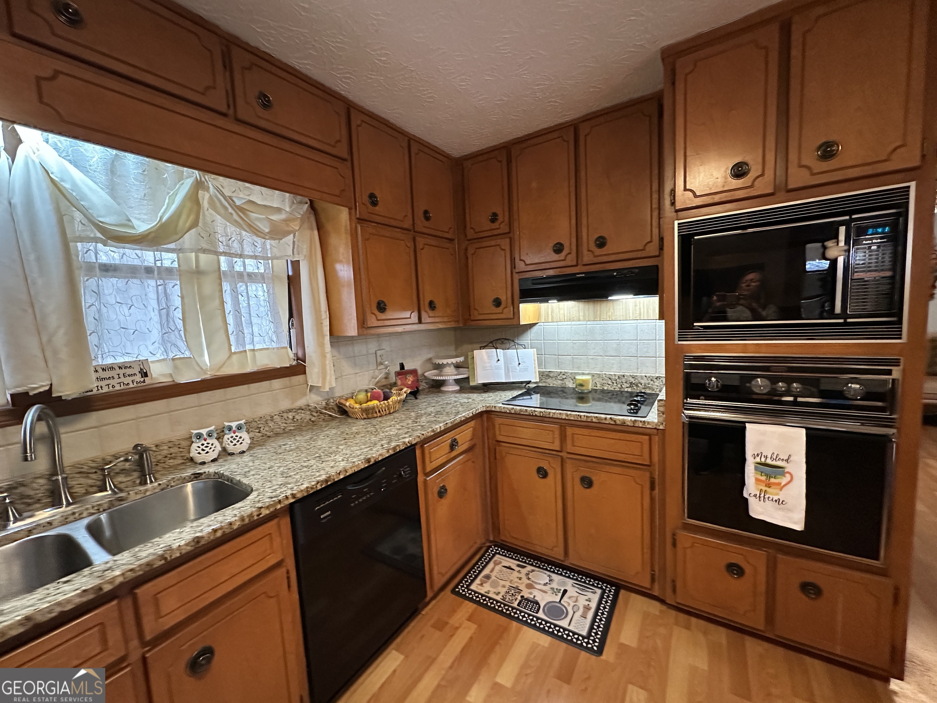 11306 Panhandle Road Hampton, GA 30228 - Photo 6 of 20 a kitchen with stainless steel appliances granite countertop a sink stove and microwave