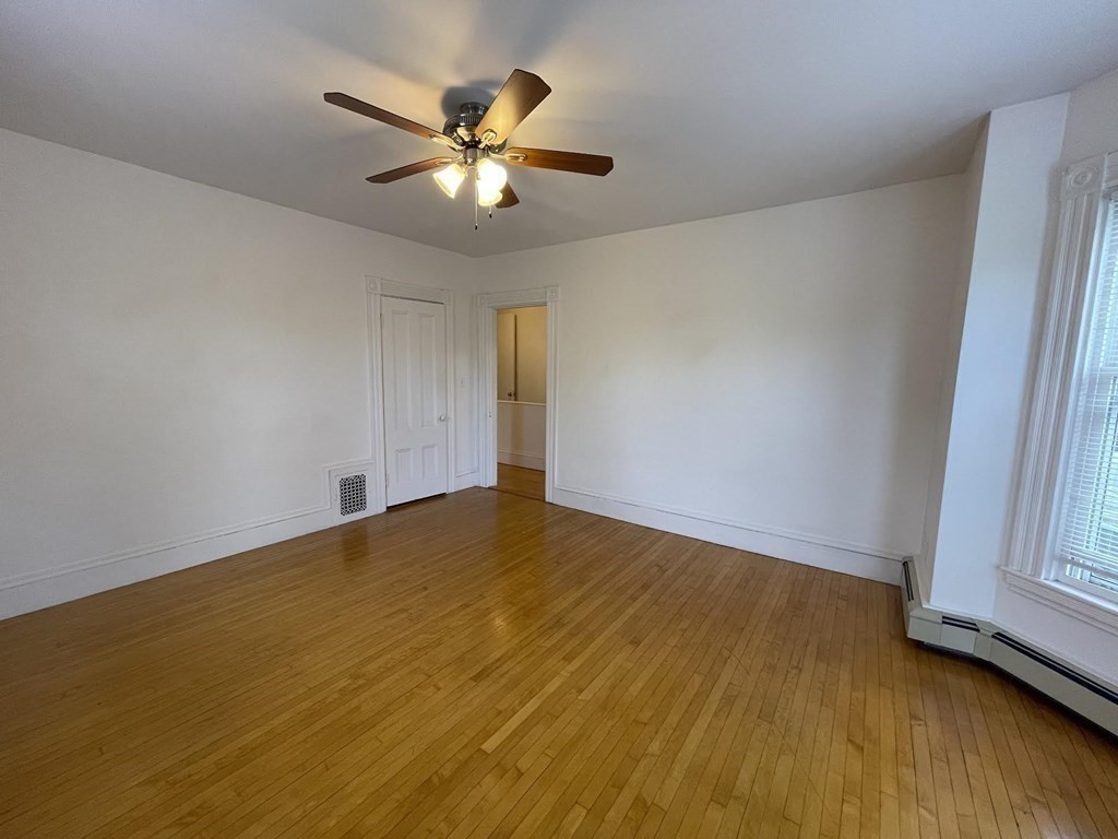 36-2 Lowell Avenue, Unit 362 Newton, MA 02460 - Photo 11 of 22 a view of an empty room with wooden floor and a window