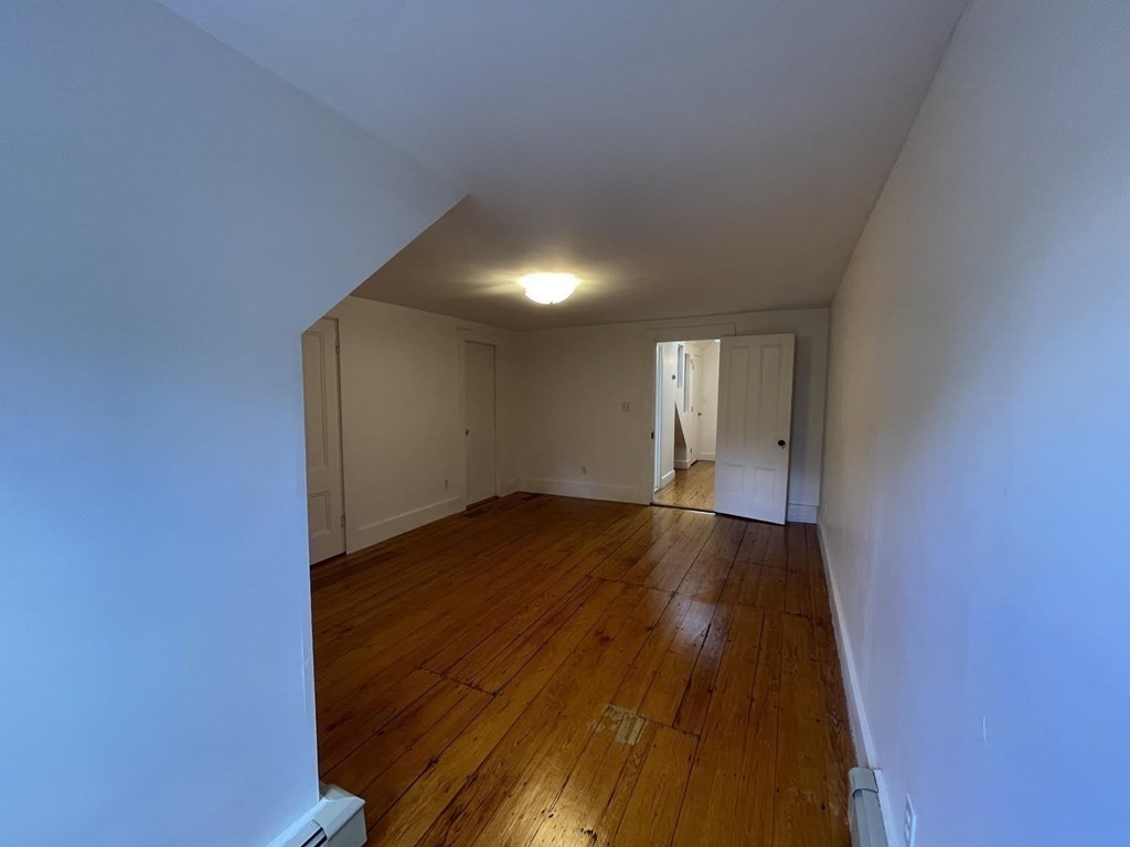 36-2 Lowell Avenue, Unit 362 Newton, MA 02460 - Photo 18 of 22 a view of empty room with wooden floor