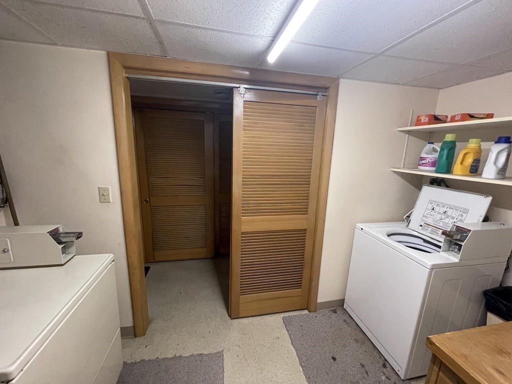 36-2 Lowell Avenue, Unit 362 Newton, MA 02460 - Photo 20 of 22 a view of storage and utility room with washer and dryer