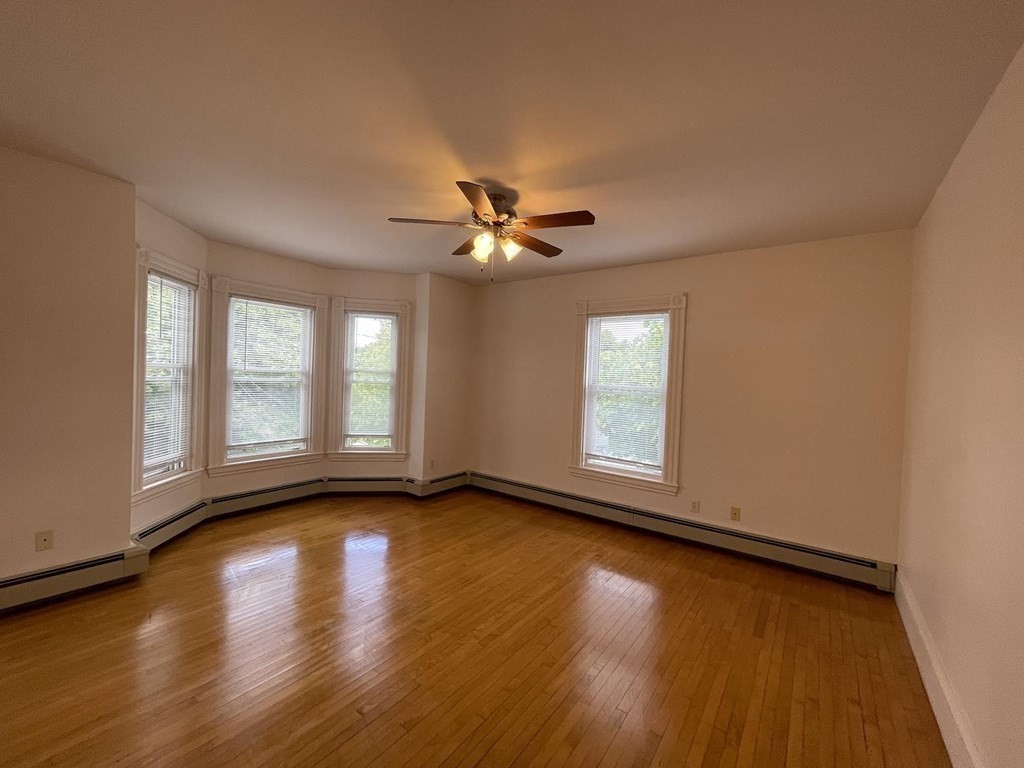 36-2 Lowell Avenue, Unit 362 Newton, MA 02460 - Photo 10 of 22 a view of an empty room with window and wooden floor