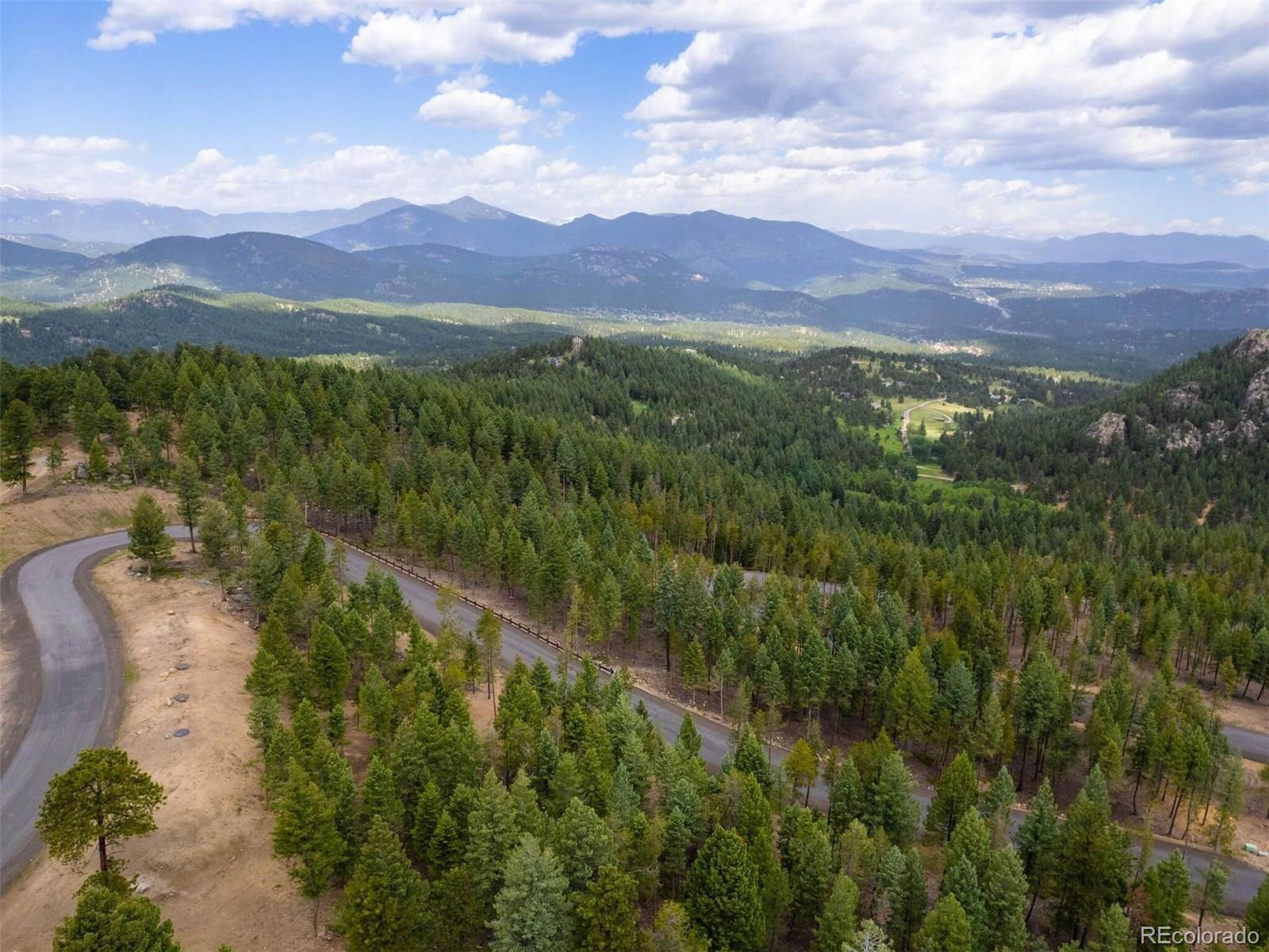 6371 Canyon Creek Road Evergreen, CO 80439 - Photo 2 of 38 a view of a city with lush green forest