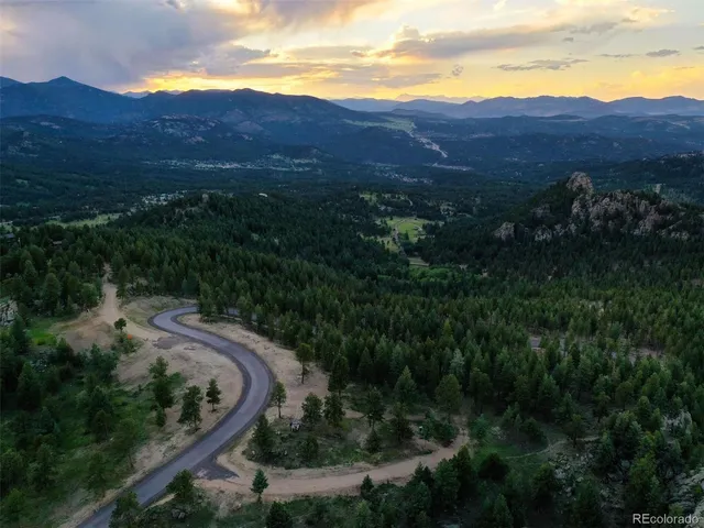 a view of a yard with wooden fence