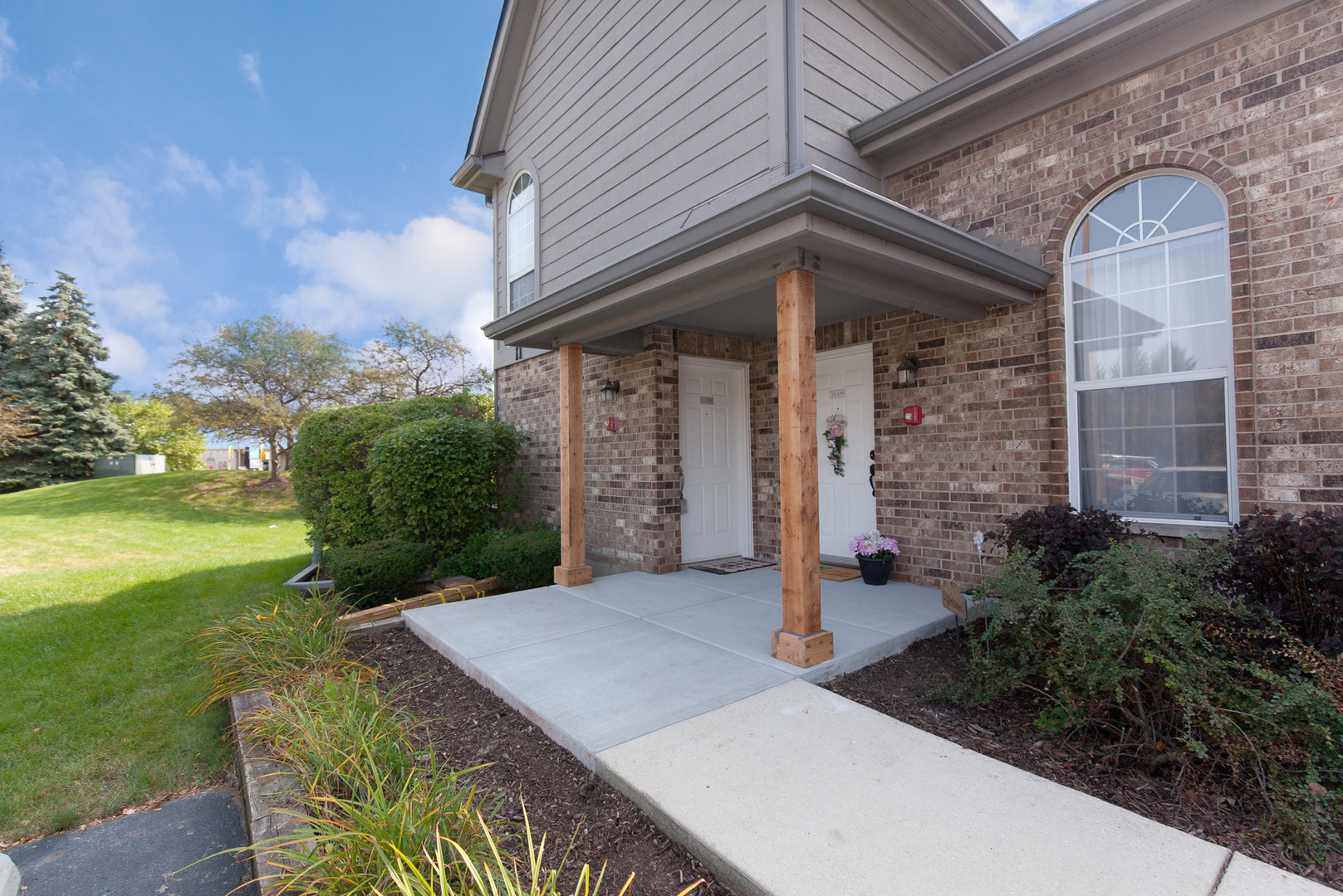 11 Foxcroft Road, Unit 239 Naperville, IL 60565 - Photo 1 of 13 a front view of a house with garden