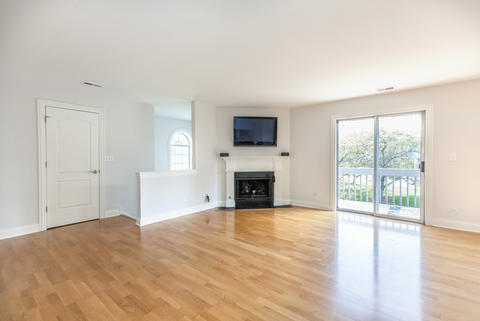11 Foxcroft Road, Unit 239 Naperville, IL 60565 - Photo 4 of 13 a view of a livingroom with a fireplace a ceiling fan and windows