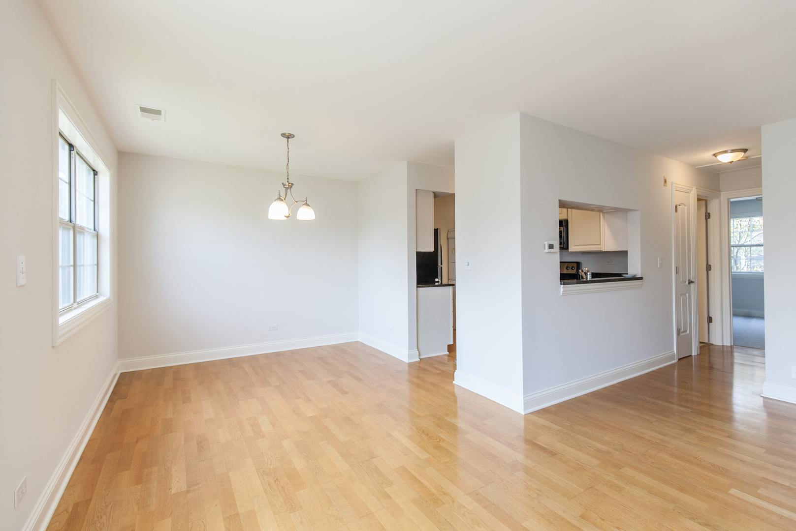 11 Foxcroft Road, Unit 239 Naperville, IL 60565 - Photo 5 of 13 a view of a kitchen with wooden floor and a window