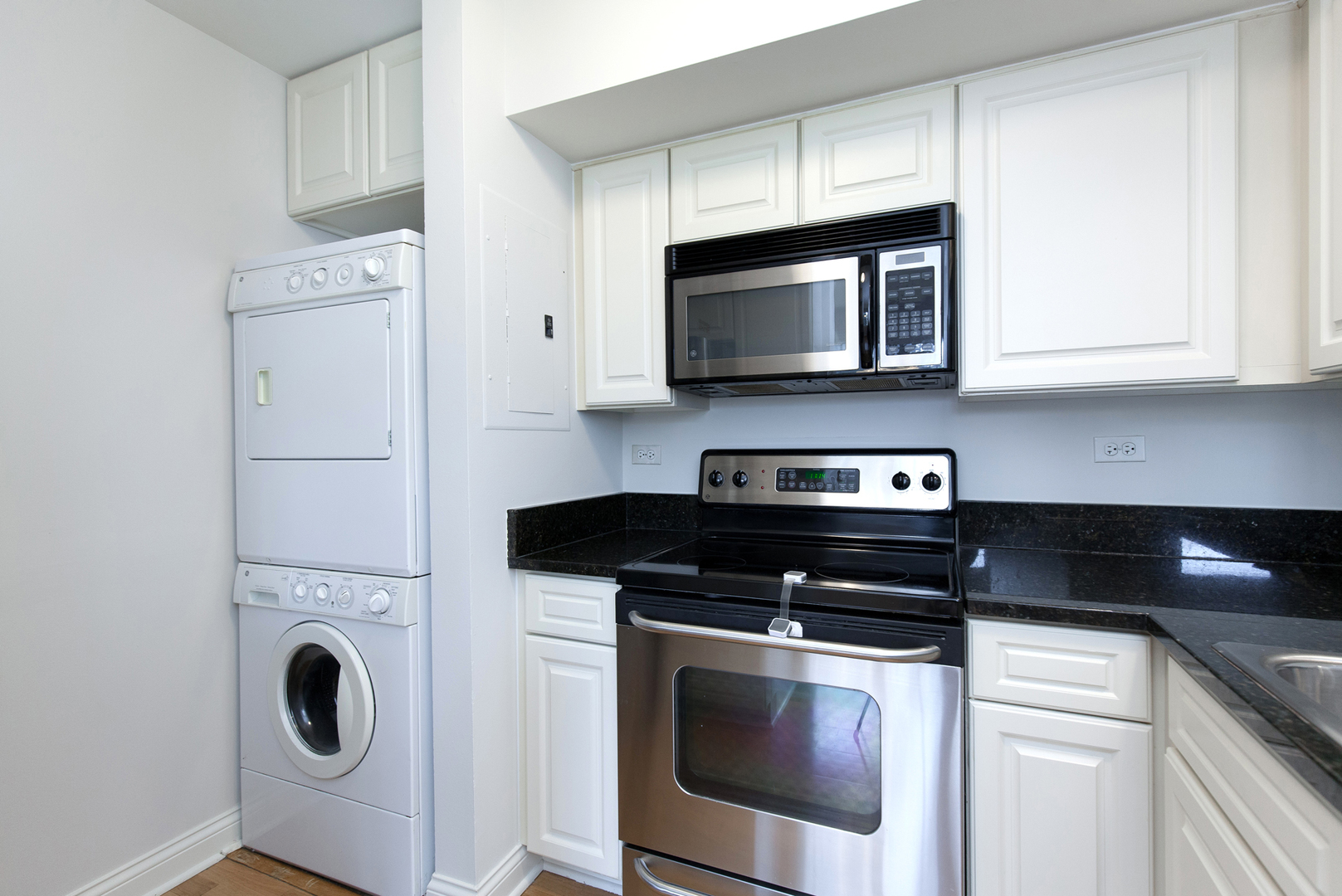 11 Foxcroft Road, Unit 239 Naperville, IL 60565 - Photo 7 of 13 a kitchen with stainless steel appliances granite countertop white cabinets a stove a microwave and a sink