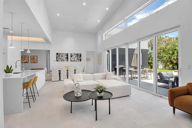 a living room with furniture and large windows