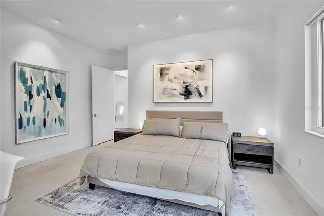 a bedroom with a bed and a painting on the wall