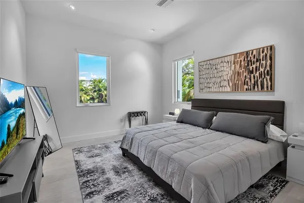 a bedroom with a bed and a painting on the wall