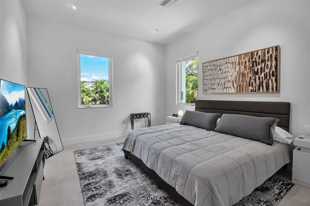 a bedroom with a bed and a painting on the wall