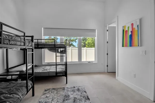 a bedroom with furniture and a window