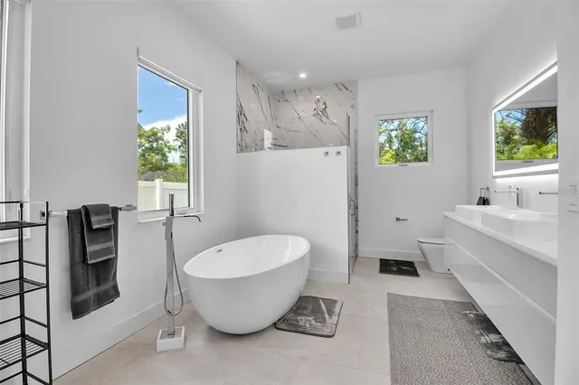 a spacious bathroom with a bathtub and sink