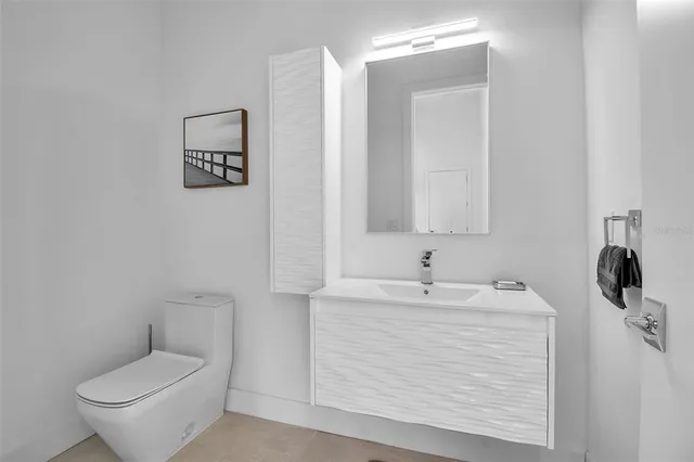 a bathroom with a sink toilet and mirror