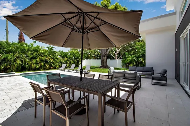 a view of an outdoor space with furniture and umbrella