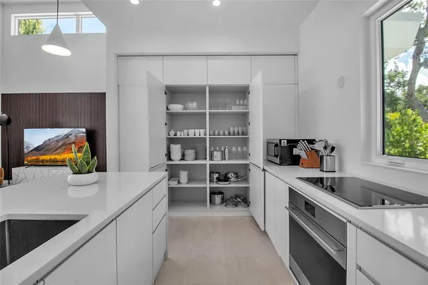 a kitchen that has a sink and a stove in it