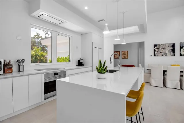 a kitchen with a sink cabinets and window