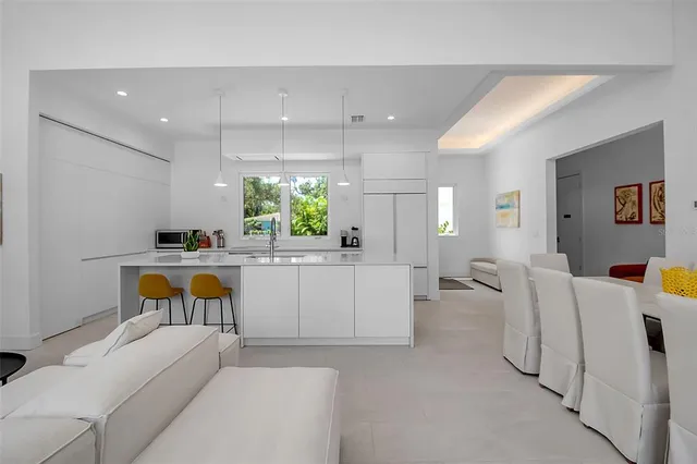 a living room with furniture and a kitchen