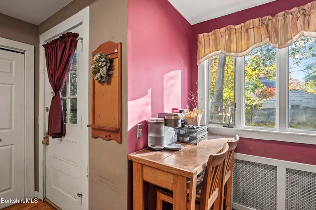 a kitchen that has a table chairs and wooden floor