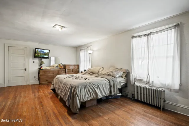 a bedroom with a bed and a desk