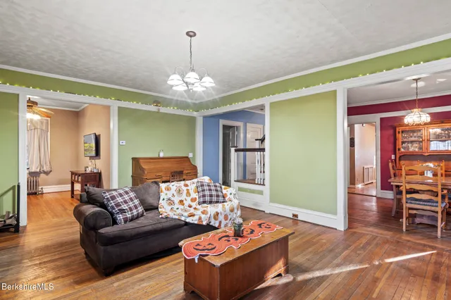 a living room with furniture and a chandelier
