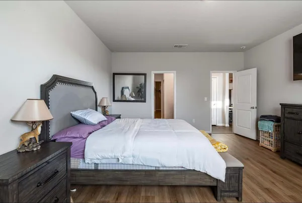 a bedroom with a bed and a chandelier