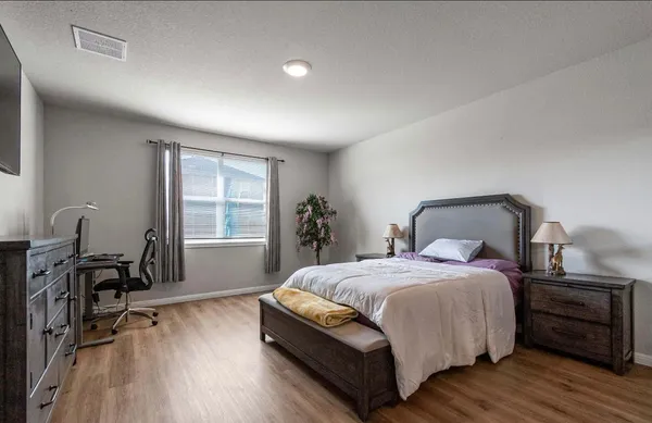 a bedroom with a bed and a table in it