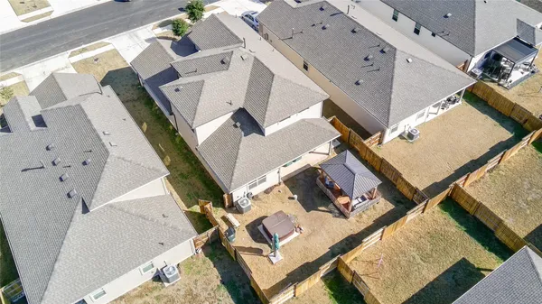 an aerial view of a house with a big yard