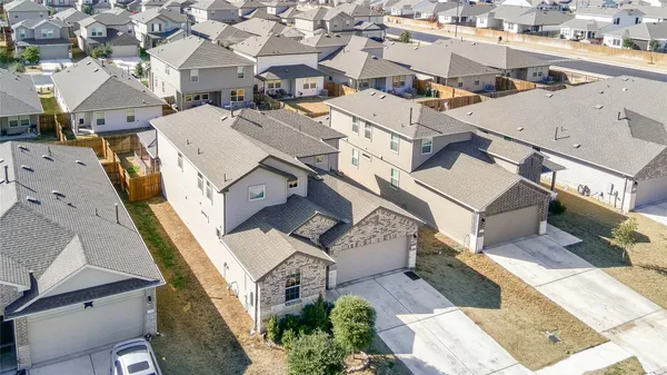 an aerial view of a residential houses with city view