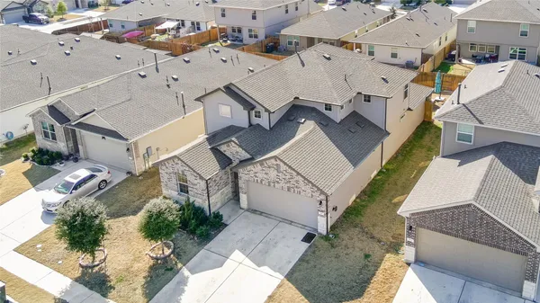 an aerial view of a house with a yard