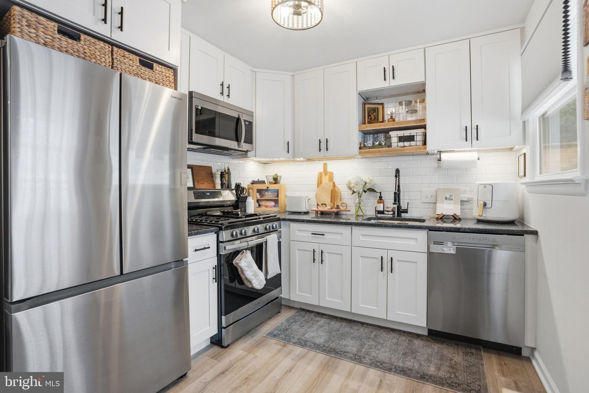 303 Radcliffe Road Glenside, PA 19038 - Photo 10 of 36 a kitchen with granite countertop a refrigerator stove and microwave