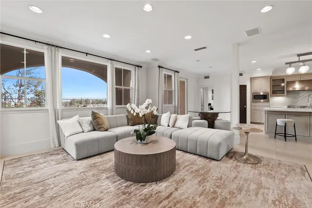 a kitchen with a table chairs microwave and cabinets