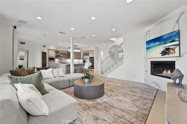 a kitchen with stainless steel appliances granite countertop a stove top oven a refrigerator and a sink