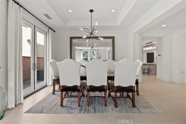 a view of a dining room with furniture and a chandelier fan