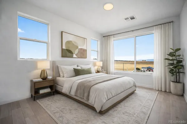 a bedroom with a large bed and a window