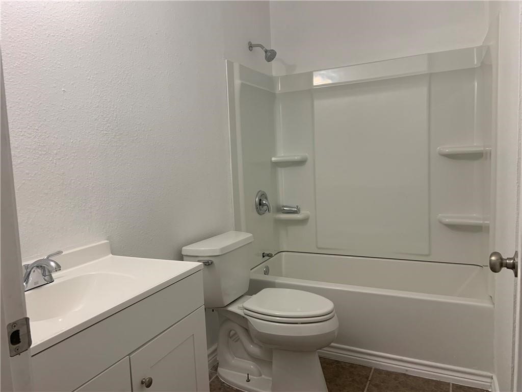 434 South 11th Street Aransas Pass, TX 78336 - Photo 11 of 16 a bathroom with a sink a toilet and a bathtub