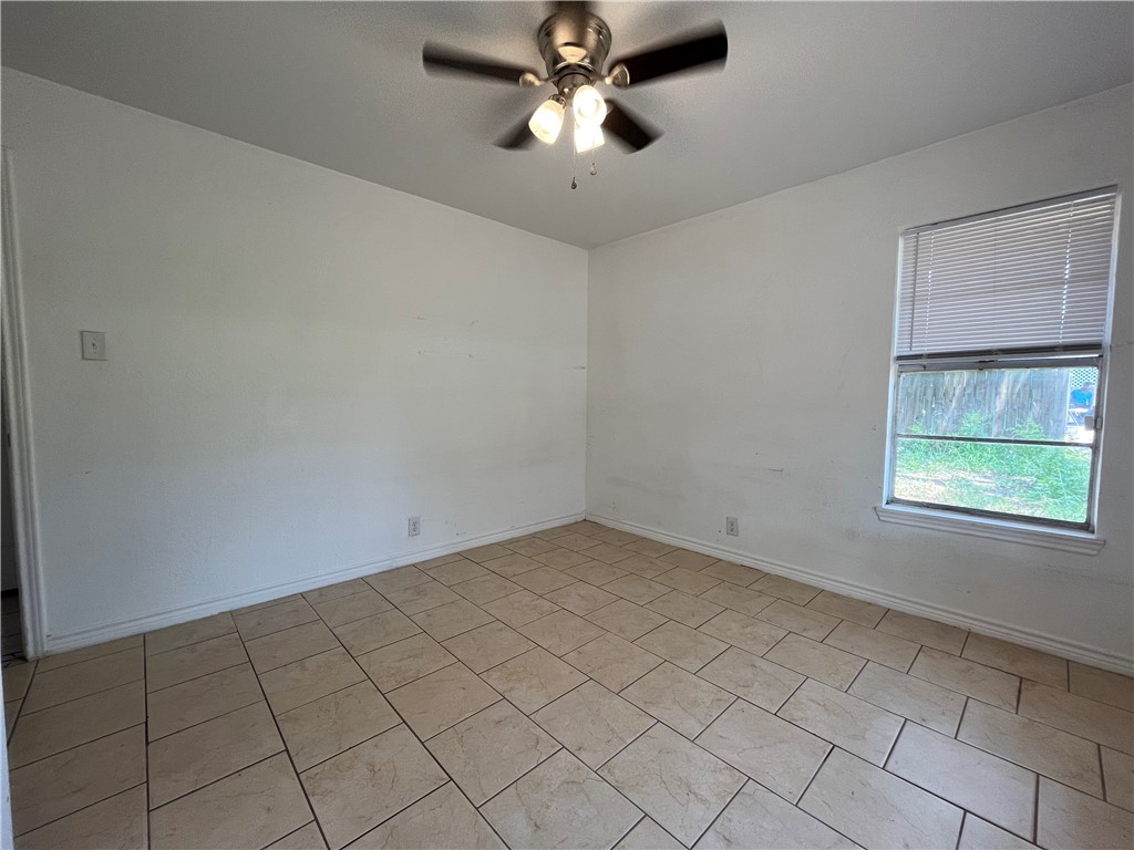 434 South 11th Street Aransas Pass, TX 78336 - Photo 12 of 16 an empty room with windows and fan