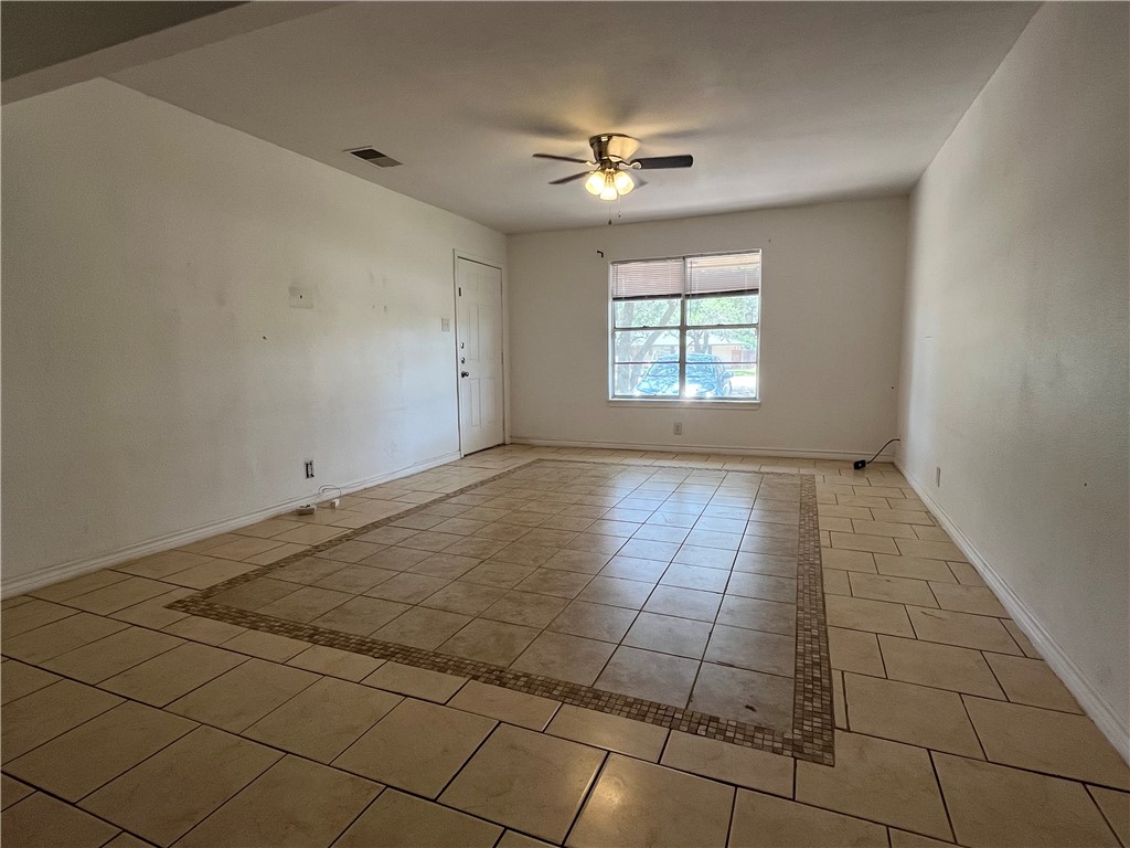 434 South 11th Street Aransas Pass, TX 78336 - Photo 3 of 16 a view of an empty room and window chandelier fan