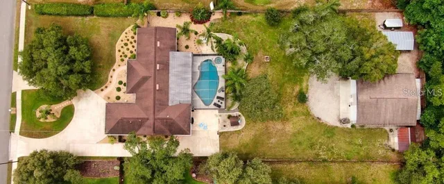 an aerial view of residential house with outdoor space and swimming pool