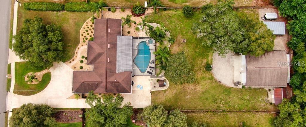 an aerial view of residential house with outdoor space and swimming pool