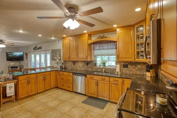 a large kitchen with a sink and cabinets
