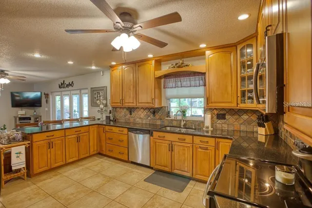 a large kitchen with a sink and cabinets