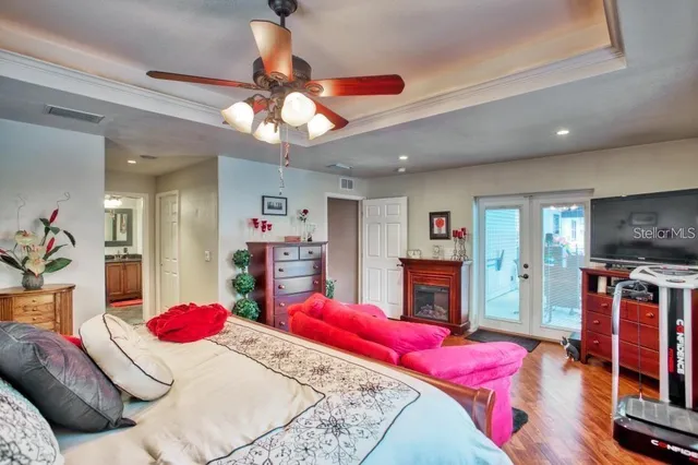 a bedroom with a bed dresser and flat screen tv